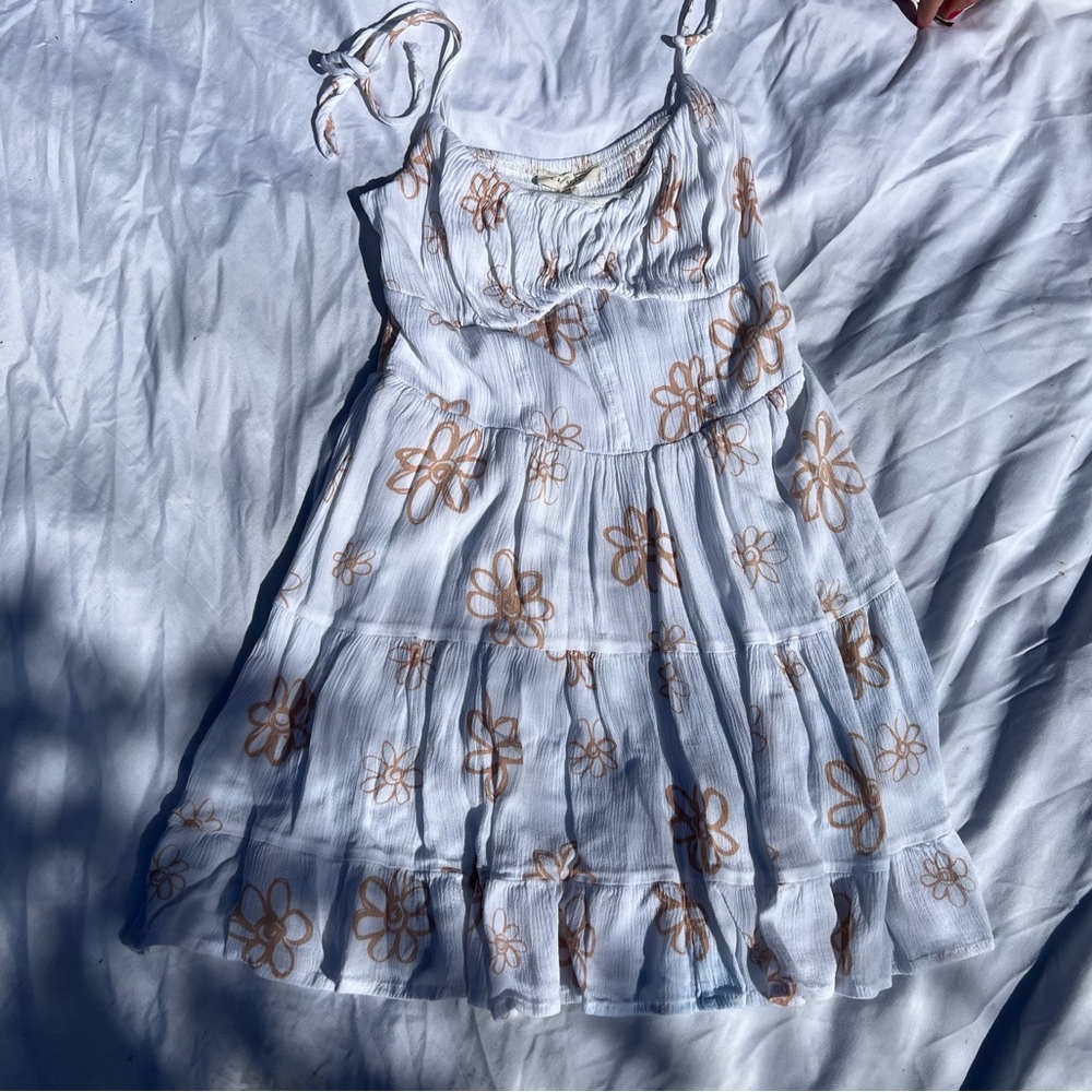 White mini dress with tan colored flower detailing